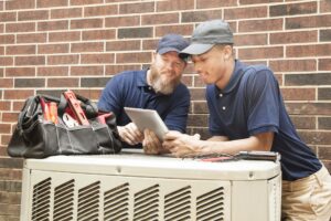 technicians-working-on-HVAC-unit