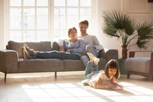 smiling-family-in-sunny-living-room