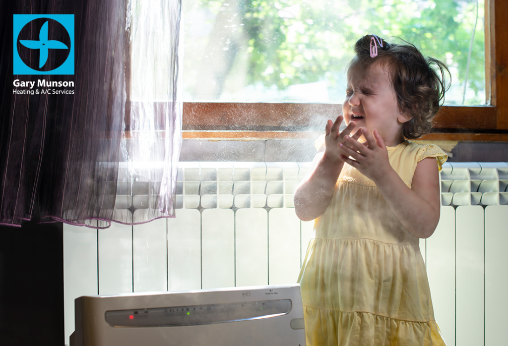 Little girl in a dusty room. Air purifier and coughing kid. Dust in the air.